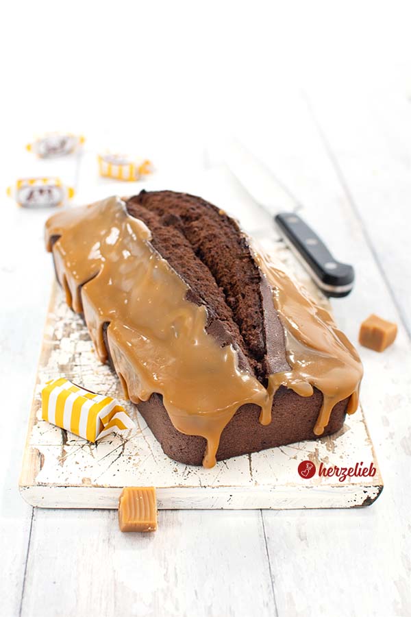 Einen Schokoladenkuchen mit Karamellguss sieht man auf diesem Bild zum Muh-Kuchen Rezept. Der Schokoladenkuchen ist mit einem Karamell Guss überzogen. Dekoriert mit verpackten und halbierten Karamell-Toffes