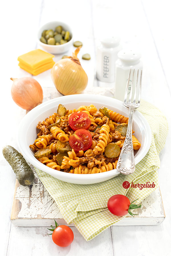Nudeltopf mit Käse und sauren Gurken in einer Schale nach einem Cheeseburger-Pasta Rezept von herzelieb.